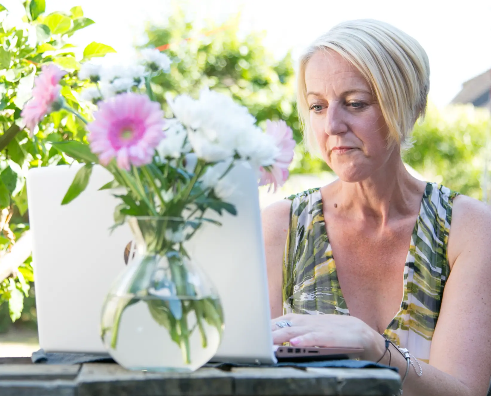 Andrea Witt providing online therapy from North Yorkshire, typing on her laptop during a virtual session